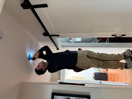 A man standing in front of a window in a room